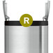 A close-up of a white simplehuman Code R trash can liner with green and black text.