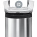A silver simplehuman Code D trash can with a white custom fit liner inside.
