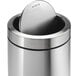 A simplehuman brushed stainless steel round swing top trash can.