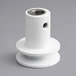 A white plastic pulley shaft with a hole in the center.