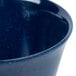 A close up of a Carlisle Dallas Ware blue bouillon cup with speckles.