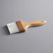 A Thunder Group pastry / basting brush with a wooden handle and white nylon bristles.