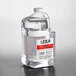 A clear bottle of Leola liquid wax with a red label.