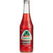 A close up of a Jarritos Strawberry Soda bottle with red liquid in it.