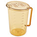 A Cambro amber plastic measuring cup with a lid and handle.