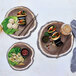 A Tablecraft melamine platter with wood design holding a plate of food with chopsticks.