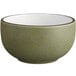 An Acopa Embers moss green stoneware bowl with a white rim.