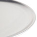 A close-up of an American Metalcraft silver aluminum pizza pan.