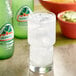 A close-up of a glass of Jarritos Grapefruit soda with ice.