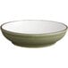 A close up of an Acopa moss green stoneware pasta bowl with a white rim.
