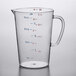 A Carlisle clear polycarbonate measuring cup on a counter with numbers on it.