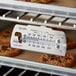 A Taylor 5921N oven thermometer in an oven.