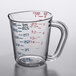 A Carlisle clear polycarbonate measuring cup with red and blue measurement markings.