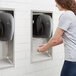 A woman using a black Lavex hand dryer.