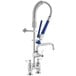 A Waterloo low profile deck-mounted pre-rinse faucet with blue handles and a hose.