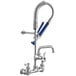 A chrome Waterloo low profile wall-mounted pre-rinse faucet with a blue hose and handle.