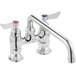 A Waterloo deck-mounted faucet with silver and red knobs.