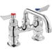 A silver Waterloo deck-mounted faucet with a red and blue handle.