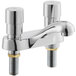 A close up of a Waterloo deck-mounted metering faucet with two handles and brass taps on a white background.