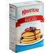 A box of Krusteaz Wheat & Honey Pancake Mix on a white background.