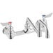 A chrome Waterloo wall-mounted faucet with two double-jointed swing spouts and two handles.