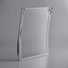 A silver rectangular mirror with a curved design.