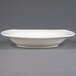 A CAC ivory square pasta bowl with a small rim on a white surface.