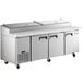 An Avantco stainless steel refrigerated pizza prep table with three doors.
