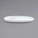A white oval porcelain plate with a small built-in well.