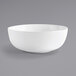 A Front of the House Harmony bright white porcelain bowl on a gray background.