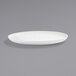 A close up of a Front of the House bright white porcelain oval plate.