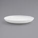 A Front of the House bright white porcelain plate with a rim on a white background.