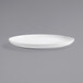 A Front of the House bright white porcelain platter with a rim on a gray surface.