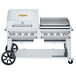 A large stainless steel Crown Verity outdoor barbecue grill with a roll dome and griddle.