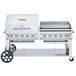 A large stainless steel Crown Verity barbecue grill with a roll dome and griddle.