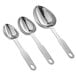 A close-up of three stainless steel Vollrath oval measuring spoons.