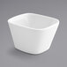 A Front of the House bright white square porcelain bowl on a gray background.