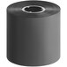 A roll of Lavex TR4085plus premium black wax ribbon on a table.