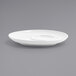 A close up of a white Front of the House round porcelain saucer.