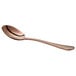 A close-up of an Acopa Vernon rose gold bouillon spoon with a white background.