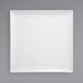 A Front of the House bright white square porcelain platter on a grey background.
