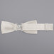 A Henry Segal ivory poly-satin bow tie with a metal adjustable band.