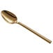 An Acopa Phoenix stainless steel dinner/dessert spoon with a long gold handle.