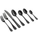 A close-up of several Acopa Vernon black stainless steel spoons.