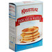 A box of Krusteaz Buttermilk Pancake & Waffle Mix on a plate with a stack of pancakes and syrup.