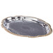 A silver metal oval catering tray with gold trim.