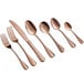 A close-up of Acopa Vernon rose gold stainless steel dinner/dessert spoons.