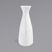 A Front of the House bright white porcelain bud vase on a gray surface.
