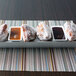A white rectangular plate of donuts with dipping sauces.
