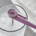 An AvaTemp purple pocket probe dial thermometer on top of a glass of ice.